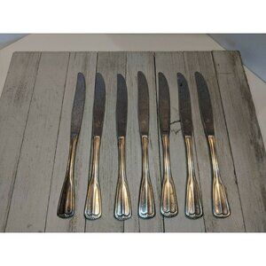 7 Stainless Steel Knives Marked "O inside Diamond" Korea Scalloped